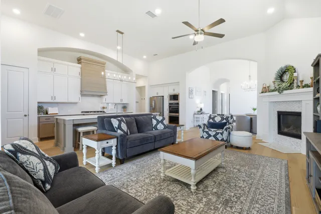 Open-plan living room connecting to a white kitchen