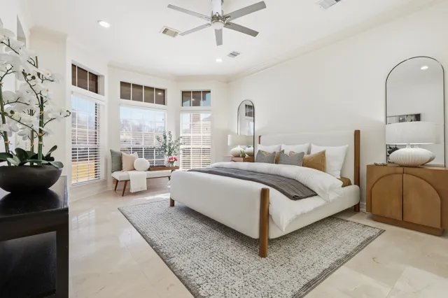 Bright bedroom with upholstered bed and large windows