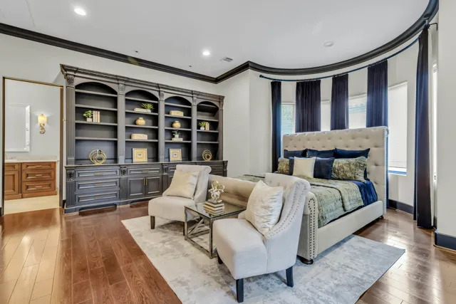 Bedroom with curved built-in shelving and reading chairs