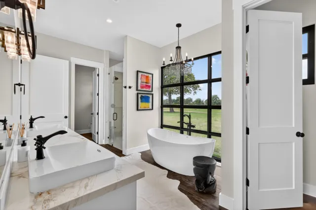 Bathroom with freestanding bathtub and black-framed windows