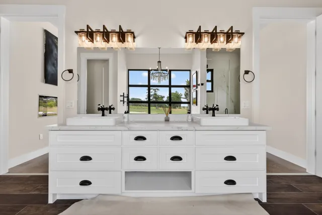 Double vanity with mirrors and warm wall lights