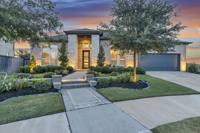 Illuminated property and pool at twilight, photographed by PRO360 Photos