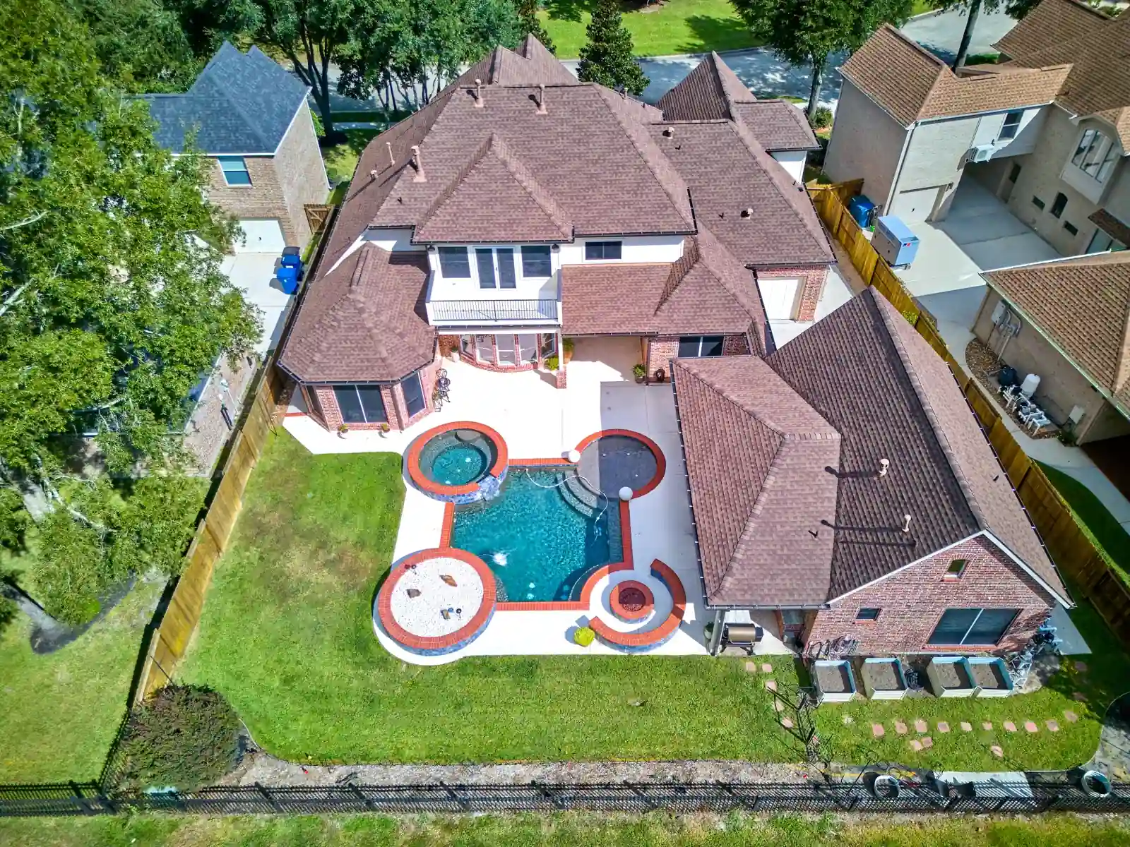 Overhead view showing a home, backyard and swimming pool