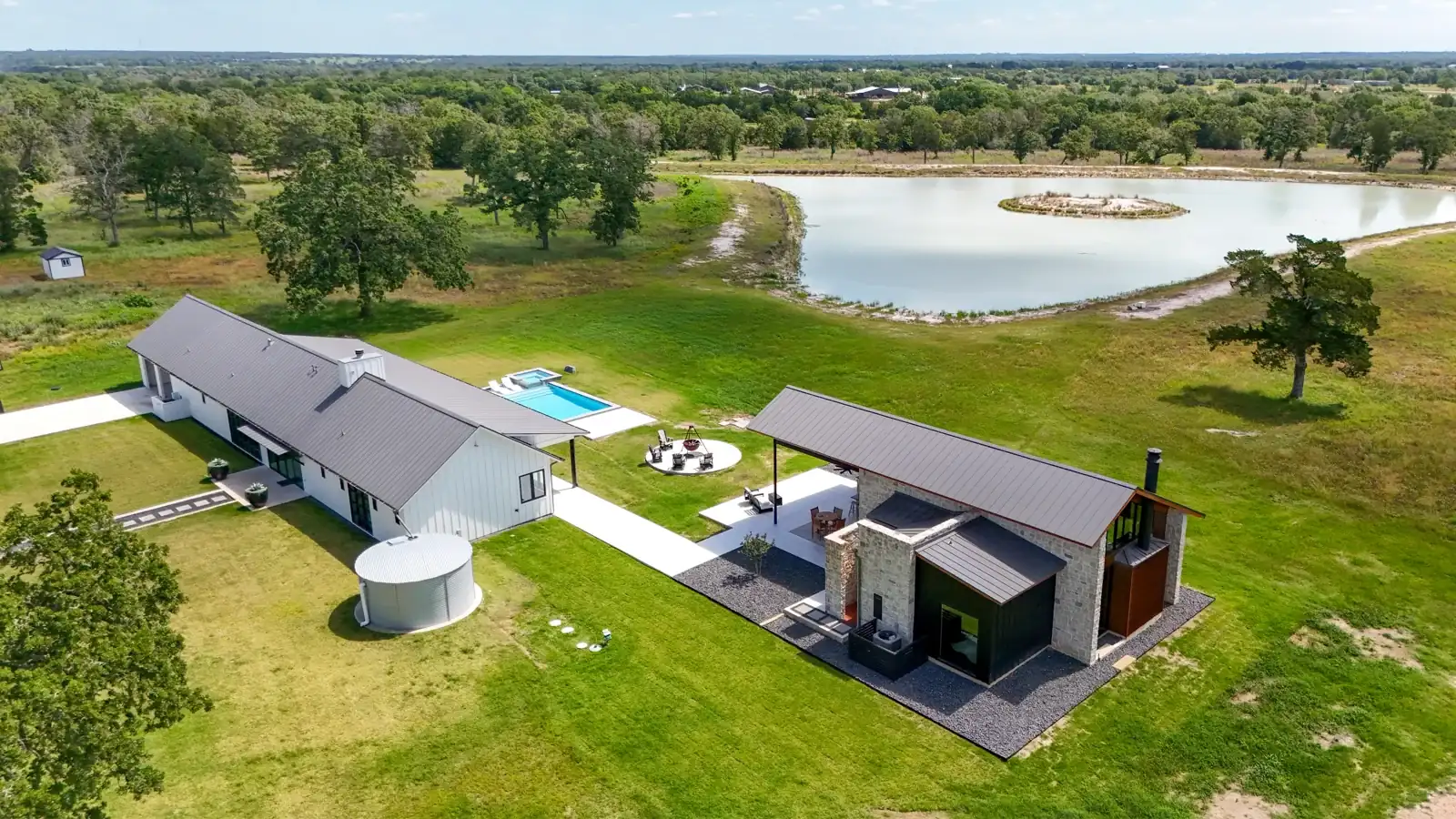 Home and outdoor structures beside a lake