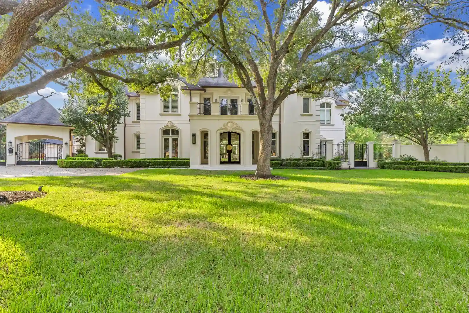 Tree-lined front elevation with brick and stone architectural details