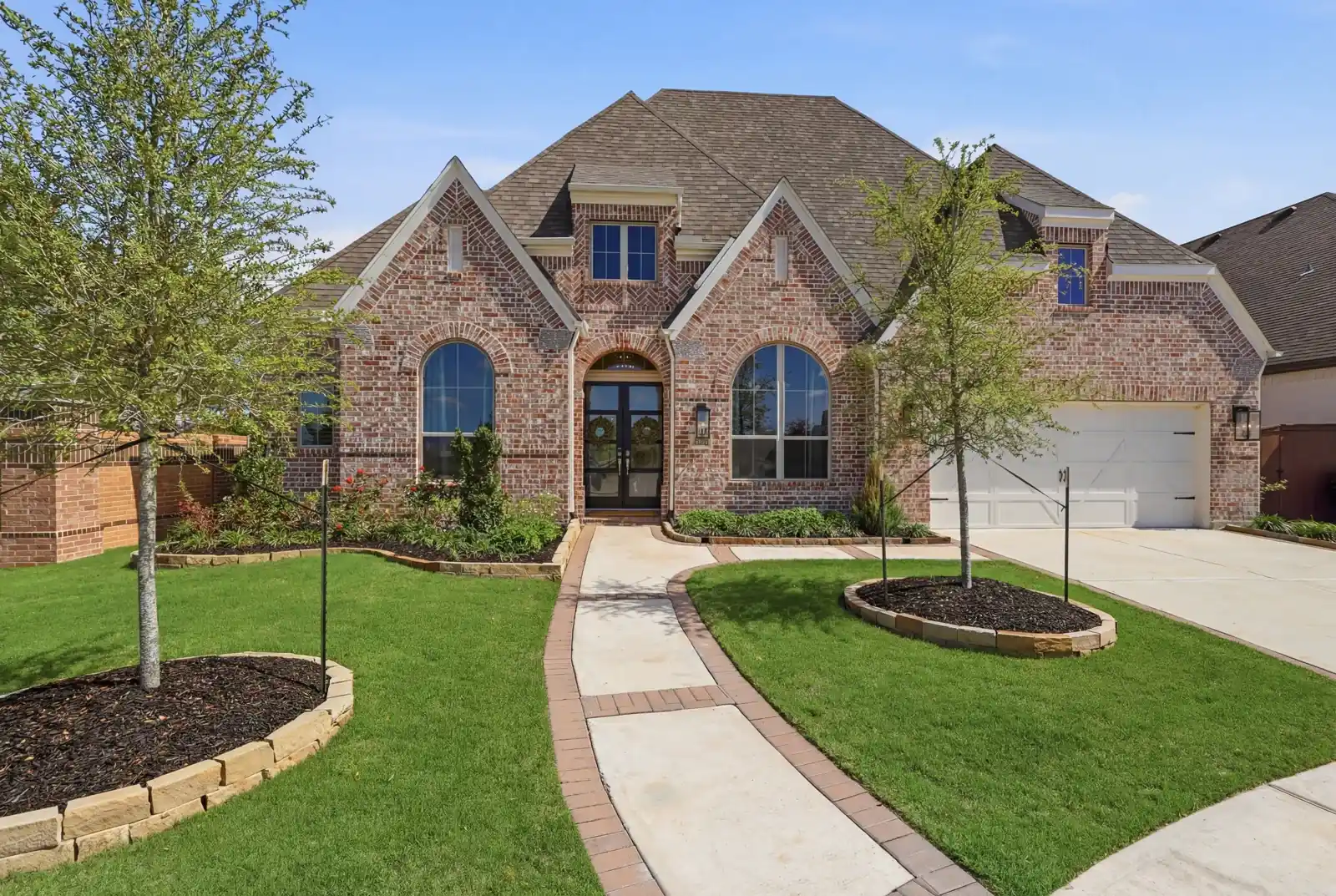 Brick front elevation with landscaped garden and entry path