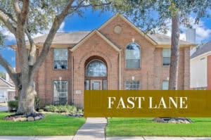 Two-story brick house with landscaping, fast lane media bundle