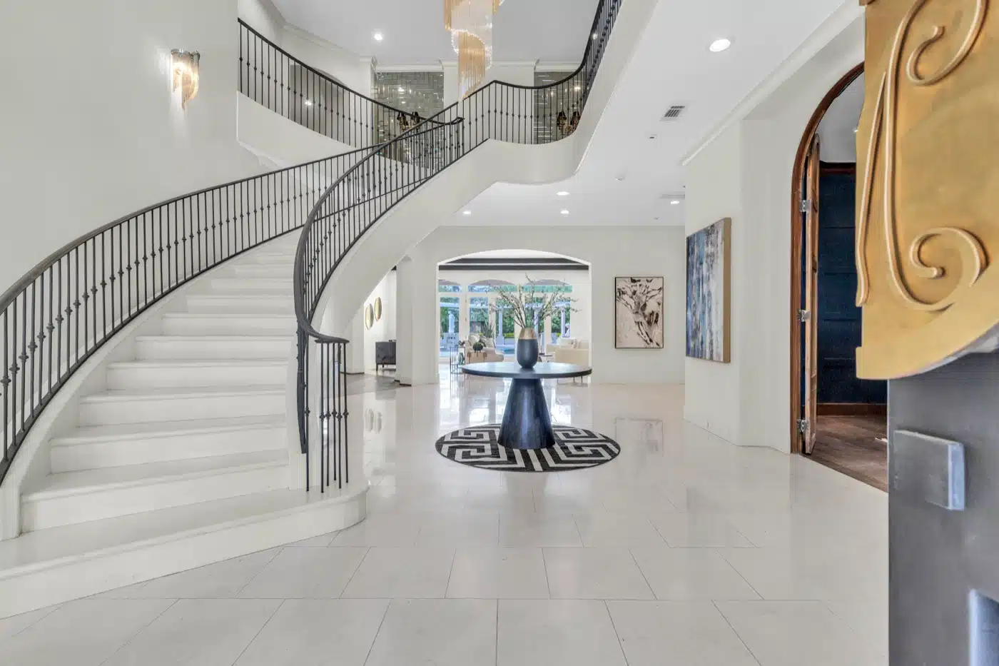 Bright foyer with a curved staircase, featured in a property video